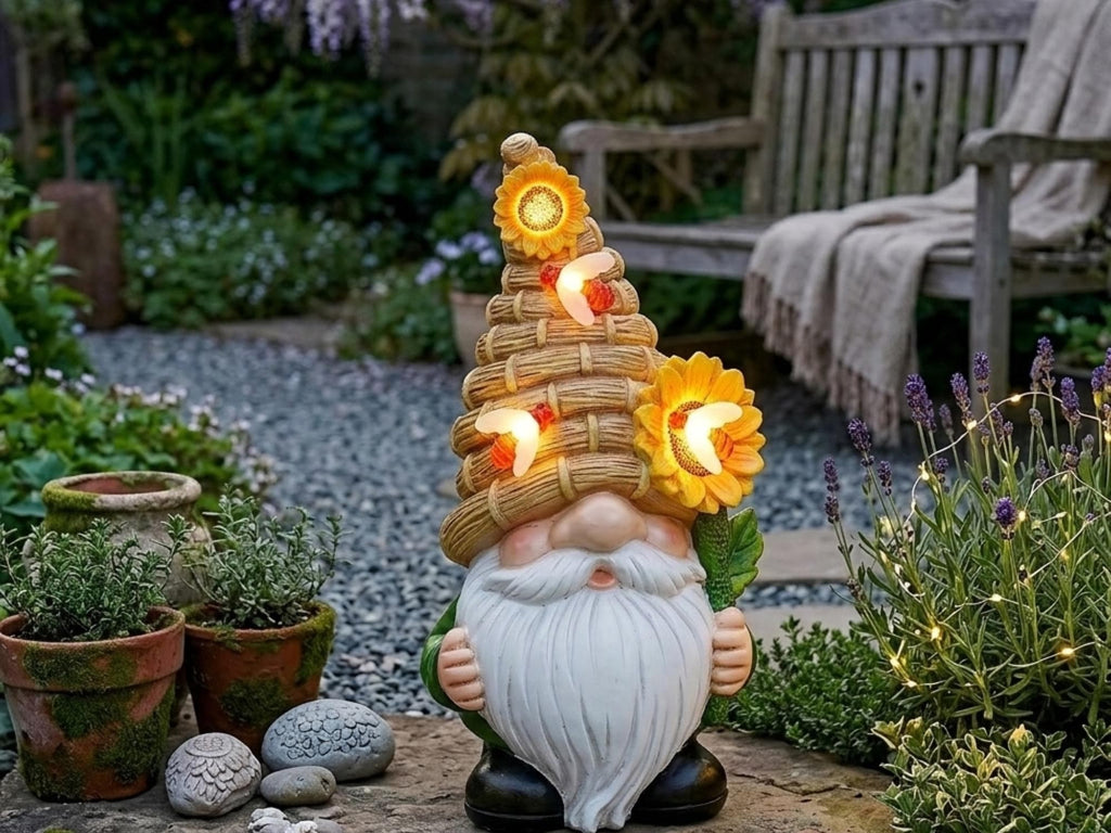 Solar beehive garden gnome surrounded by planters and stones