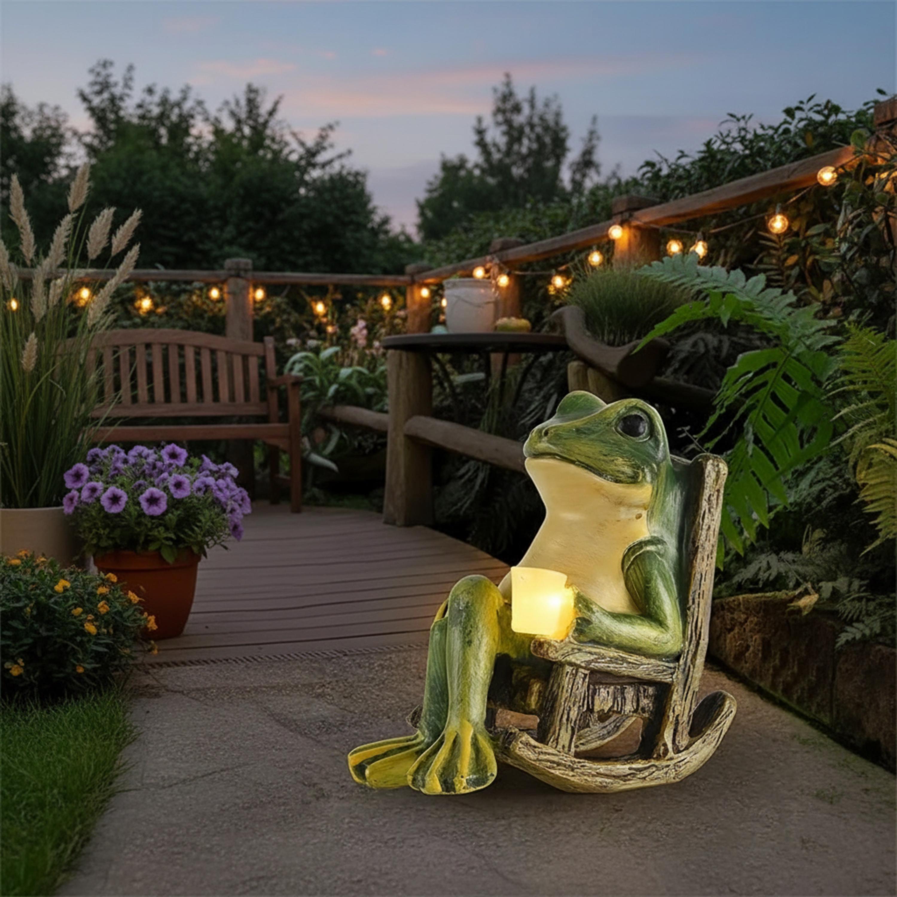 Mini solar frog garden light displayed near a backyard deck at sunset