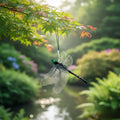 Realistic dragonfly ornament hanging from a tree branch over a garden pond