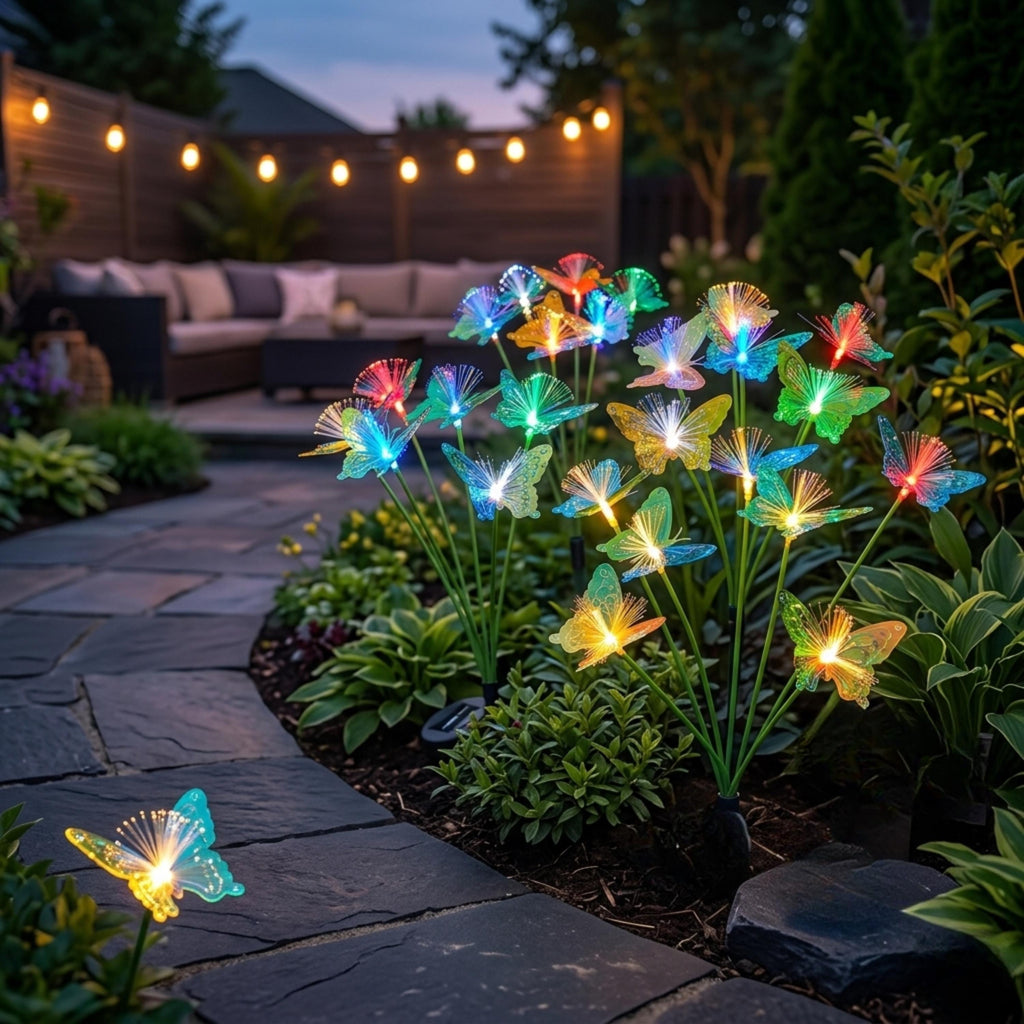 Fiber optic butterfly stake lights glowing beside an outdoor patio