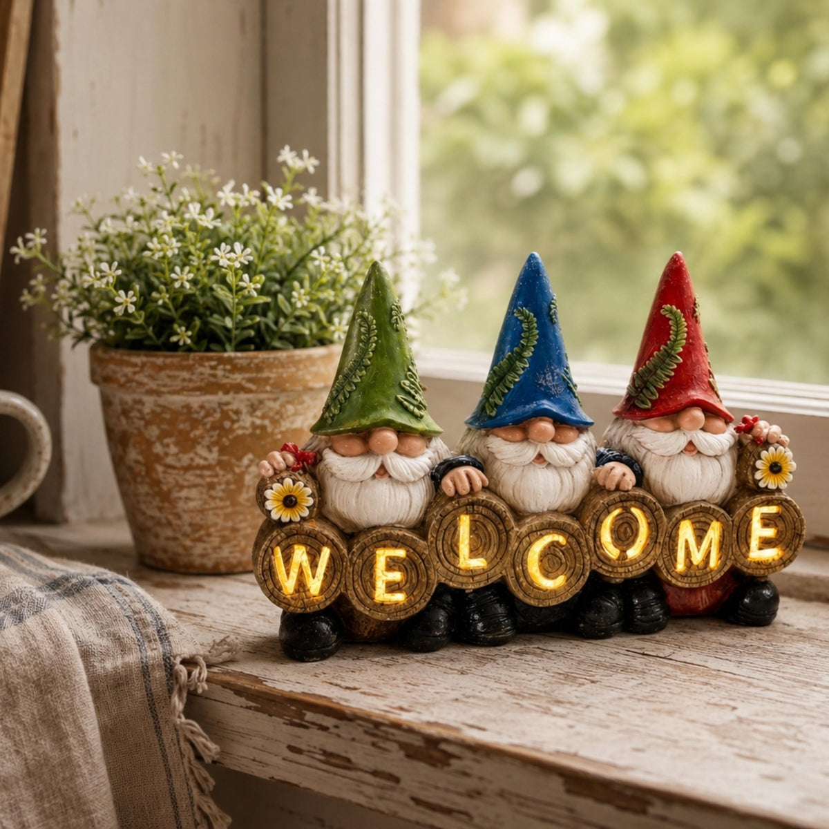 Three gnome welcome sign displayed on a rustic windowsill