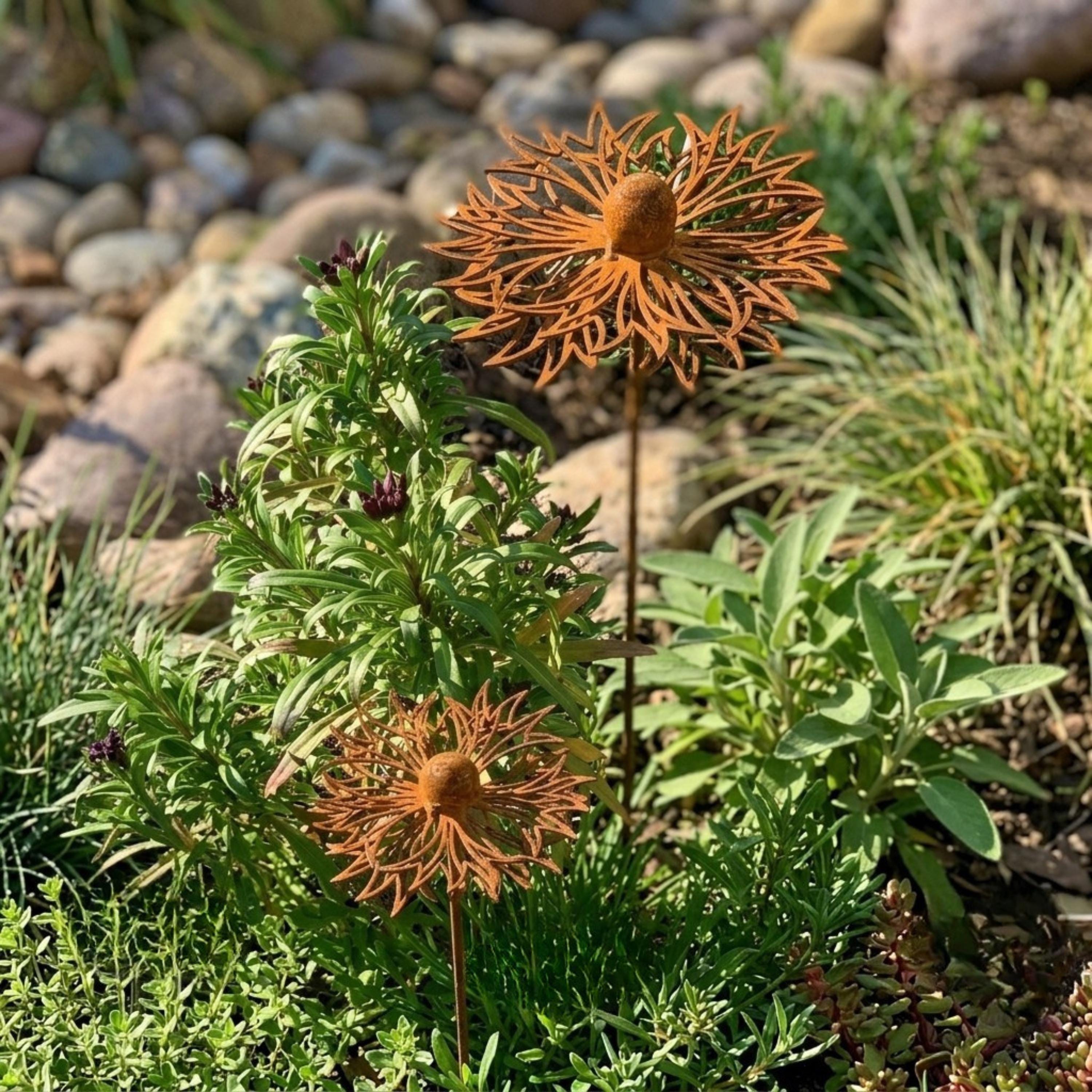 Two weathered metal flower stakes rising through green foliage