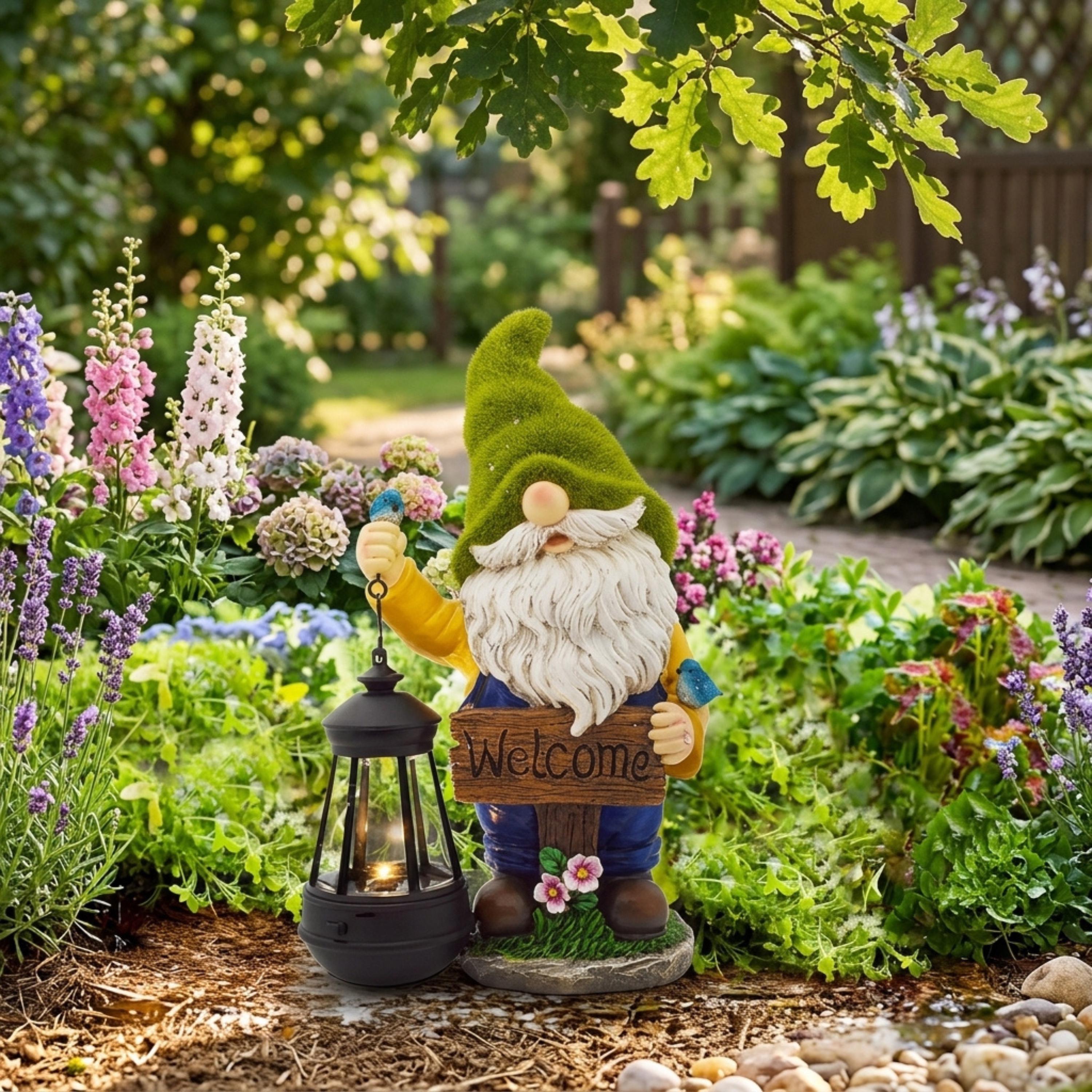 Solar welcome gnome with lantern among colorful flower beds