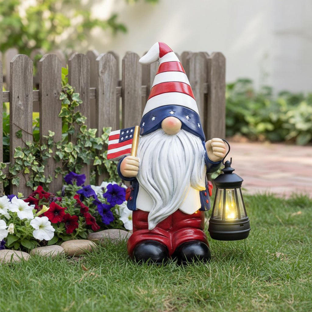 American flag solar gnome displayed near a white garden fence