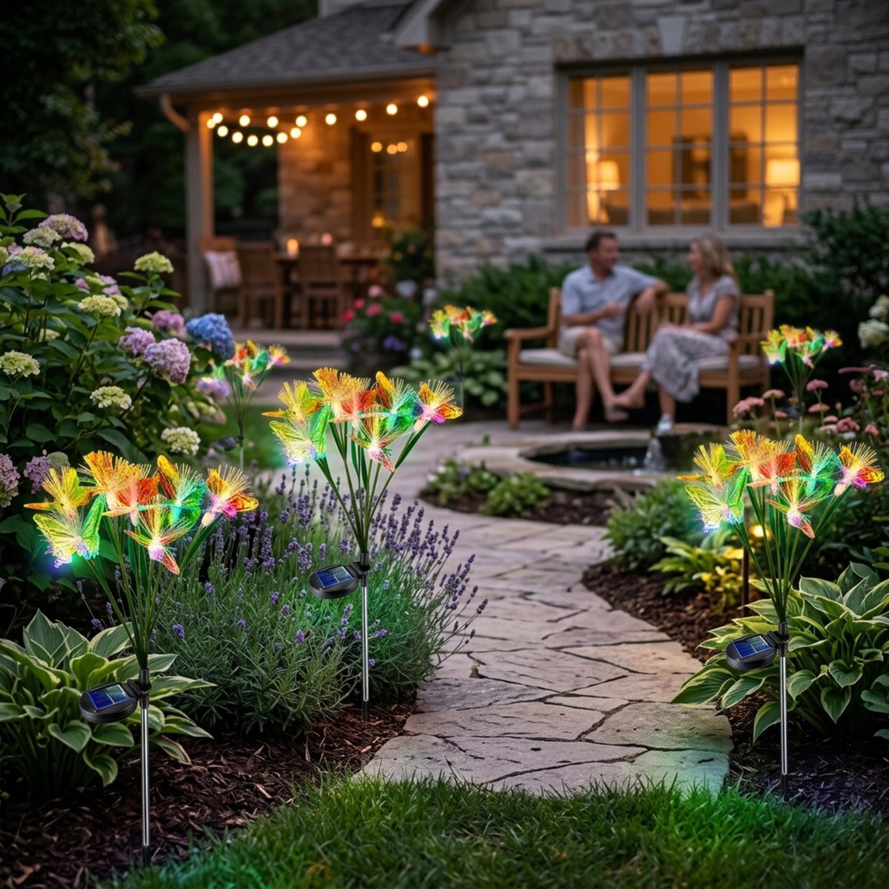 Multiple solar butterfly lights along a path near outdoor seating