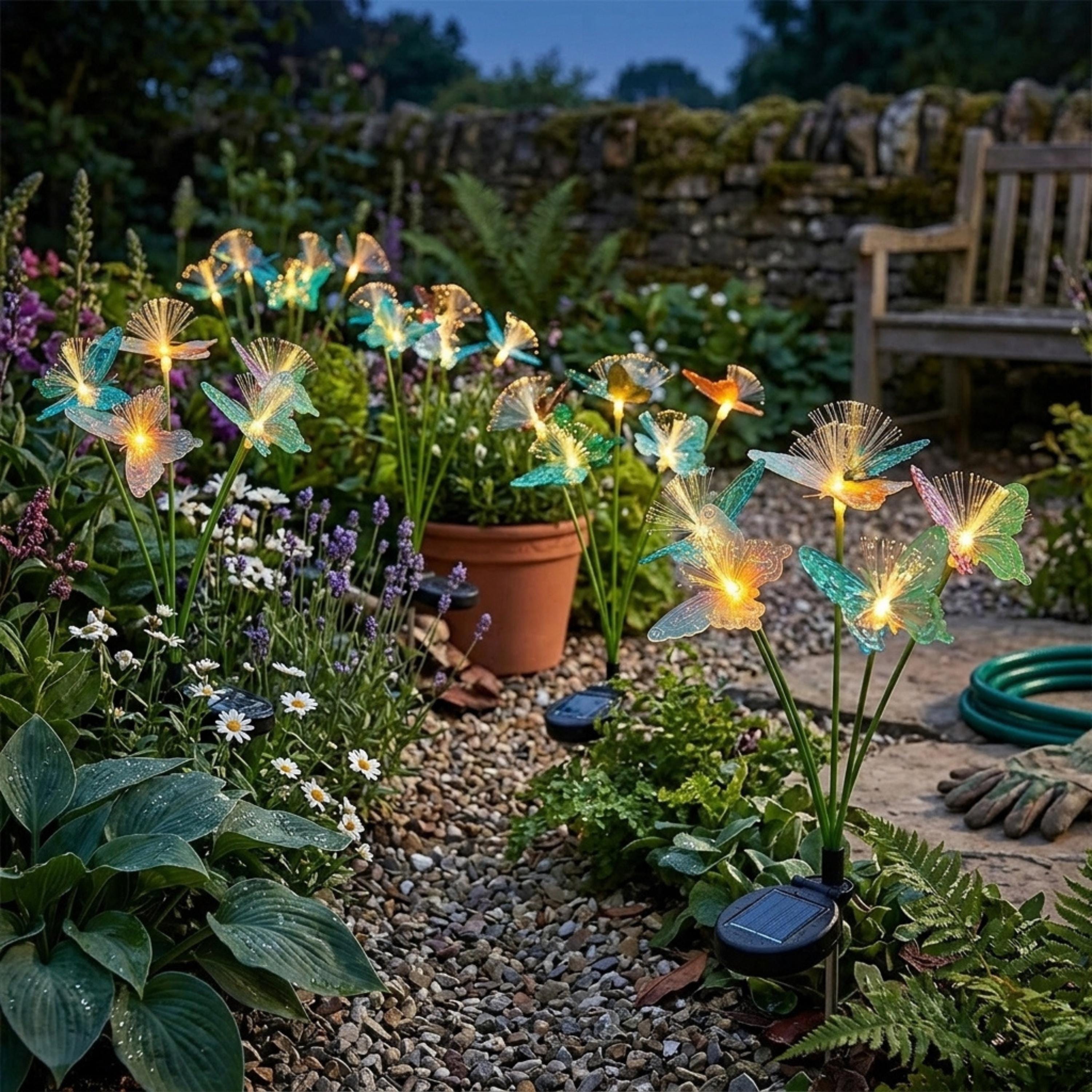 Butterfly solar stake light glowing among hostas and white flowers