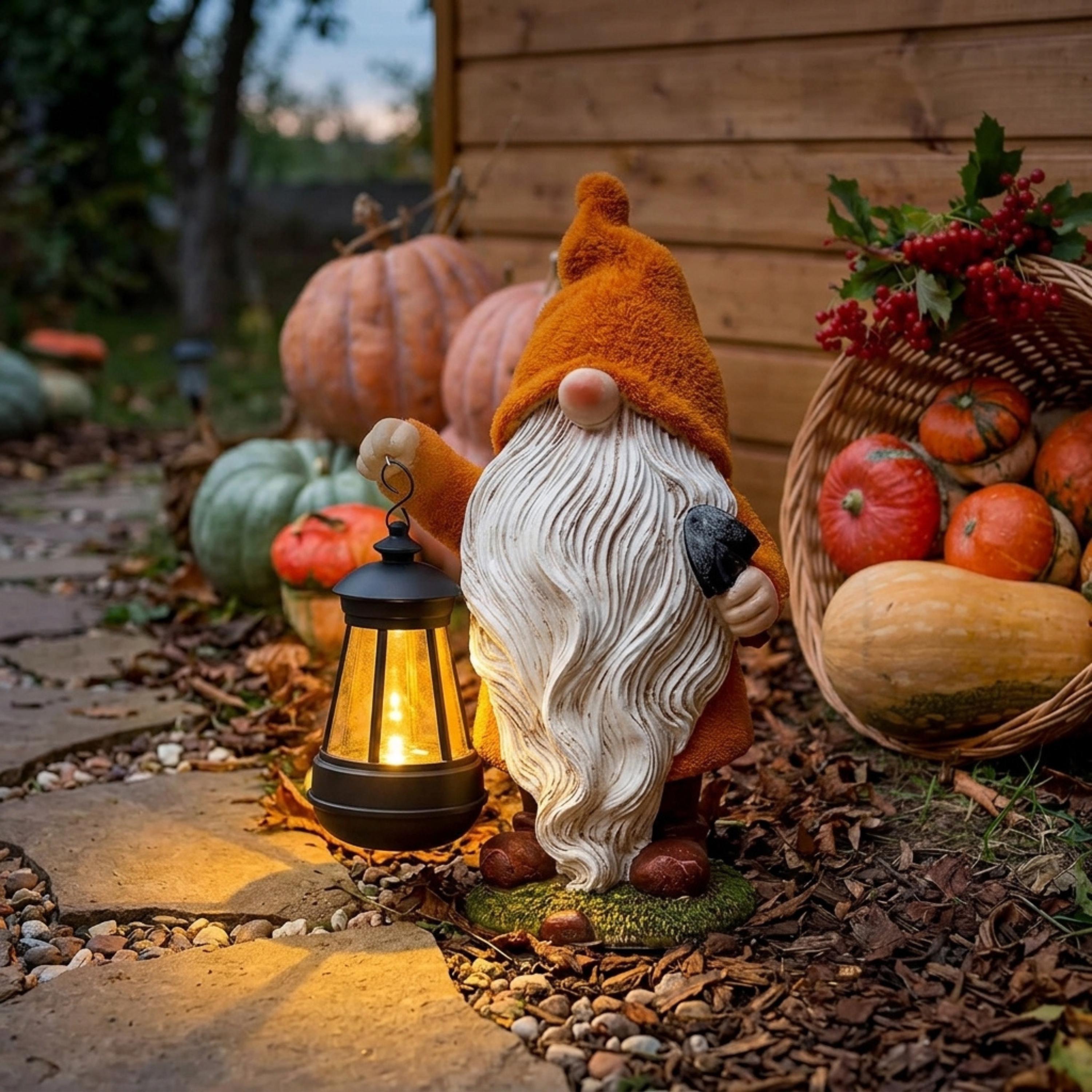Orange Halloween gnome lighting a garden path beside pumpkins