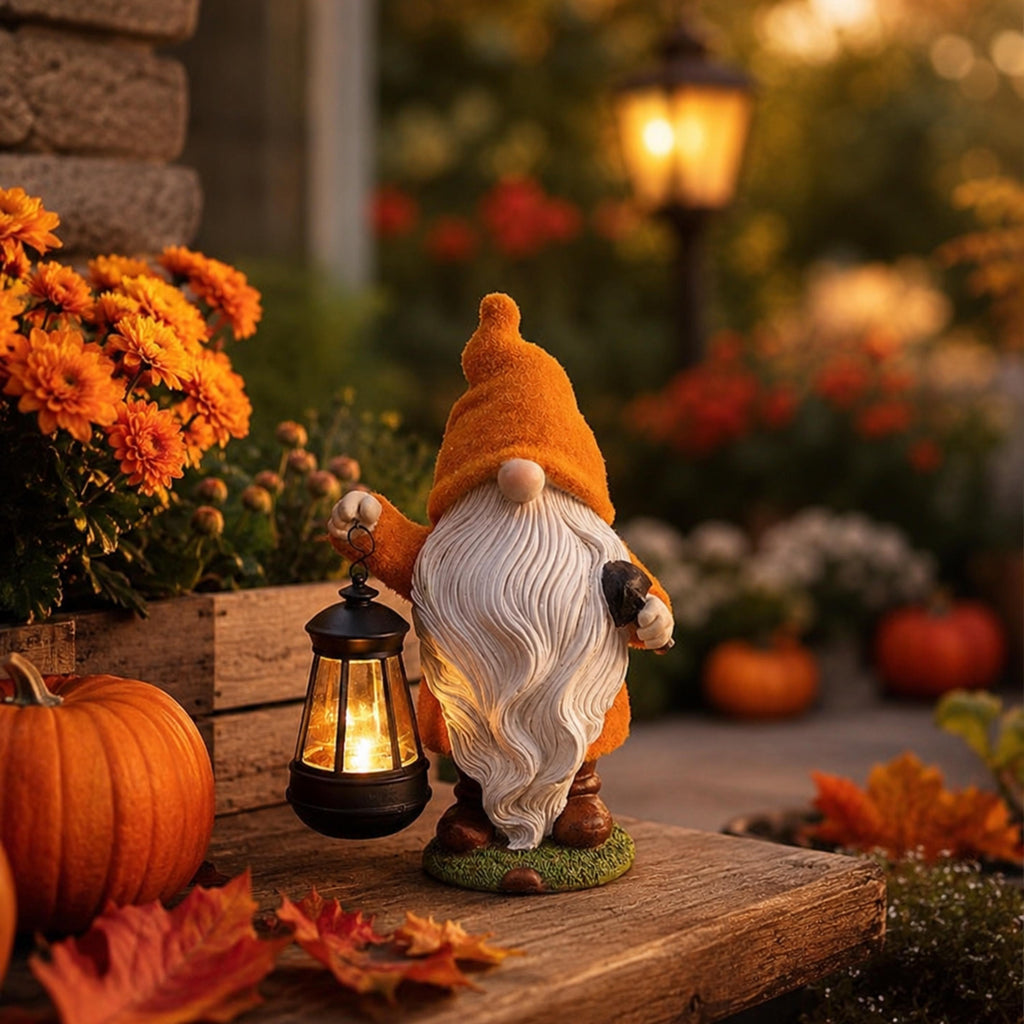 Orange-hat Halloween gnome glowing in an autumn porch display