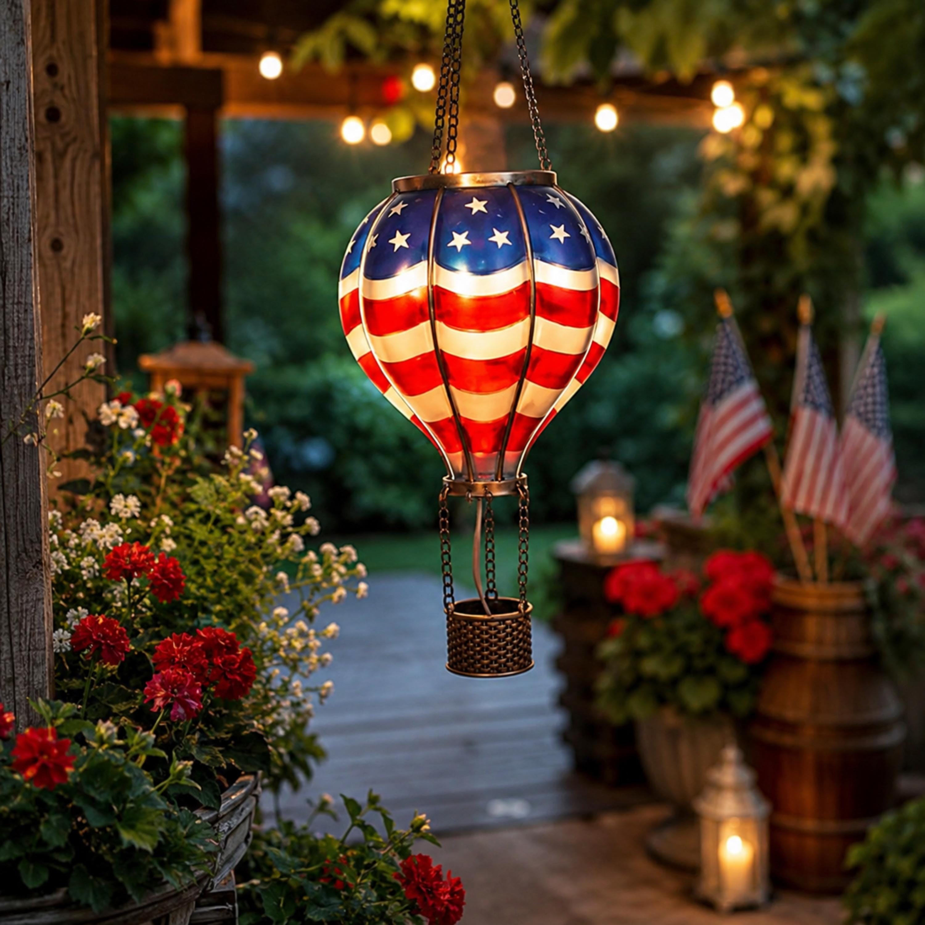 Stars-and-stripes solar garden lantern above red flowers