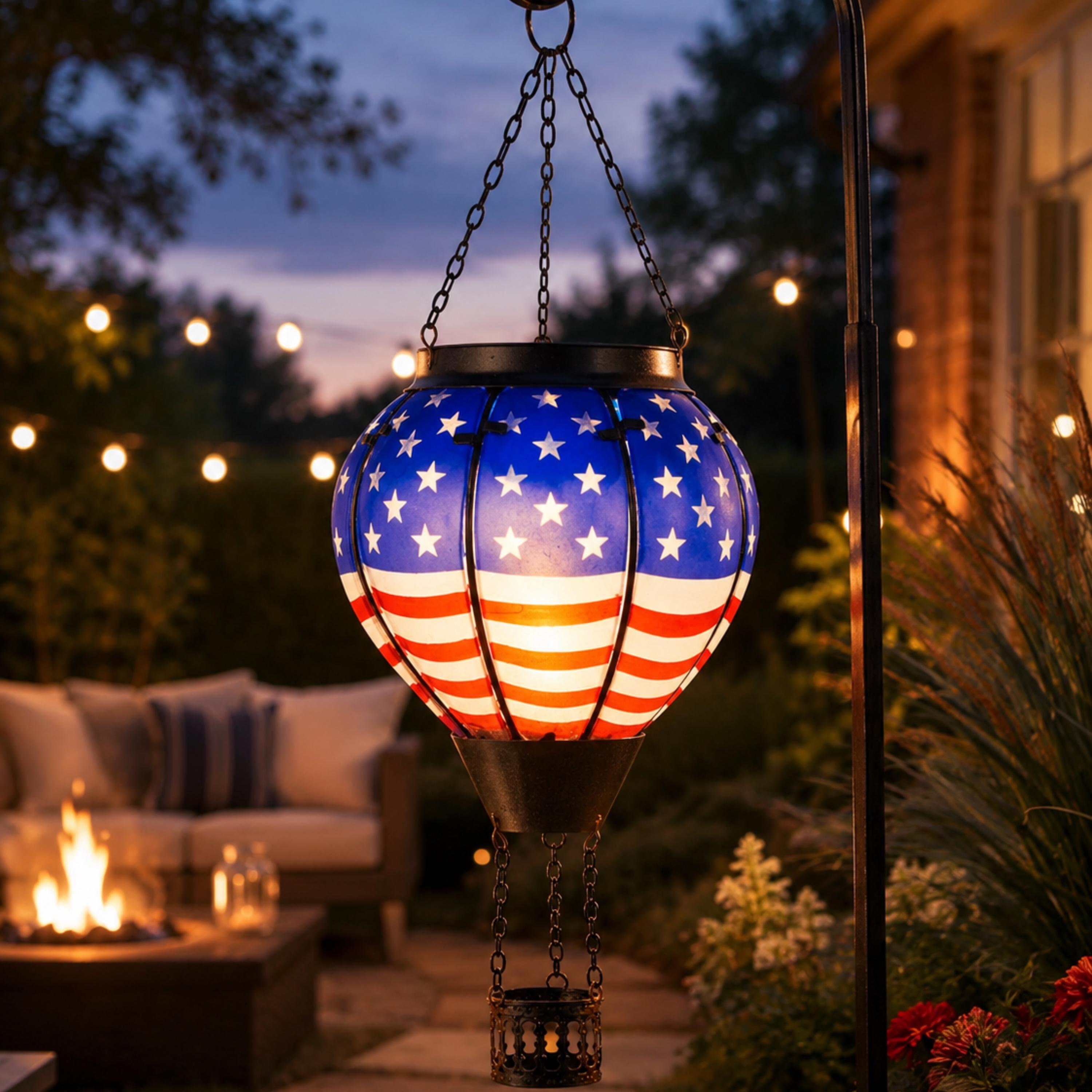 Patriotic solar hot air balloon lantern glowing over an outdoor patio