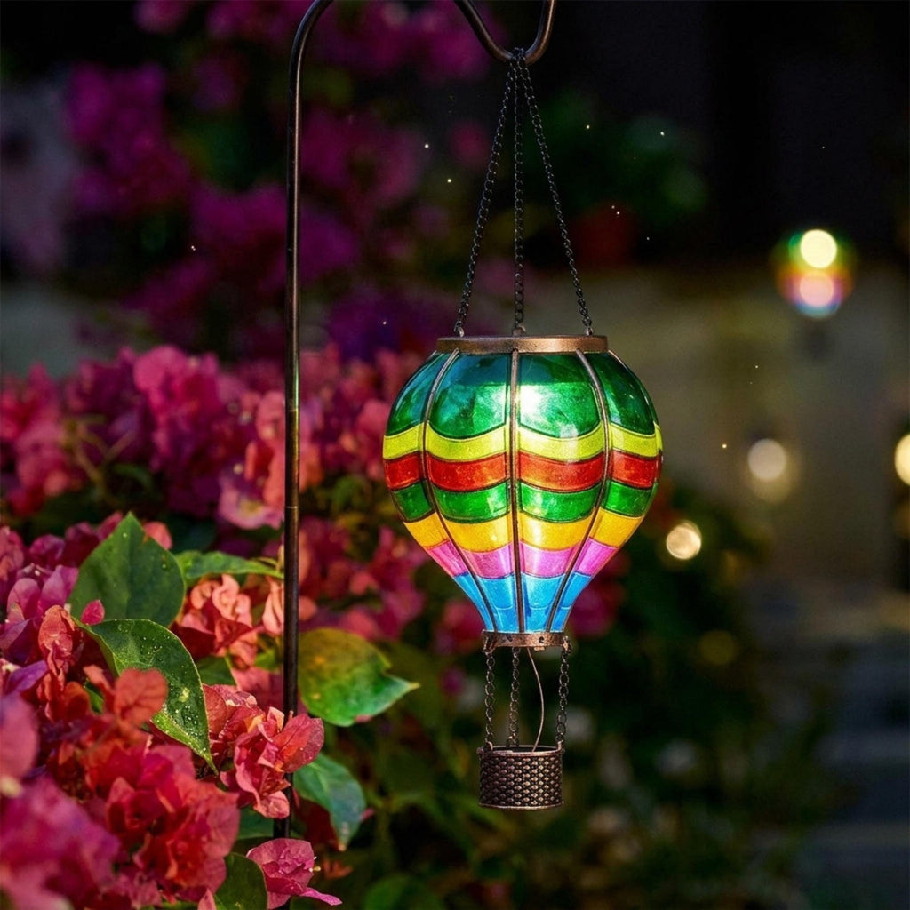 Colorful hanging balloon lantern lighting pink garden flowers