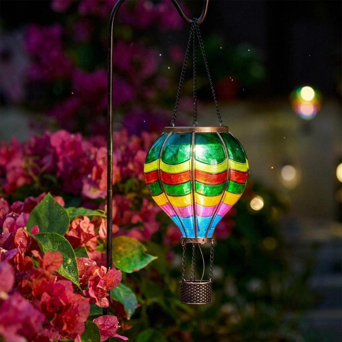 Colorful hanging balloon lantern lighting pink garden flowers