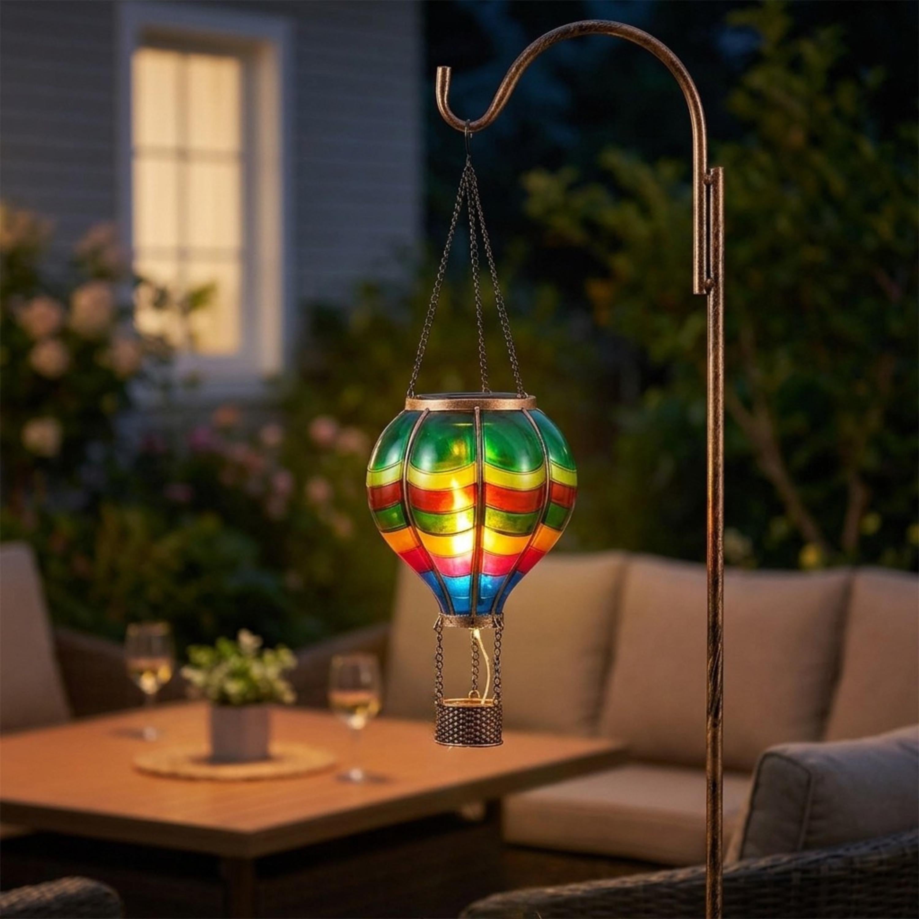 Solar hot air balloon lantern hanging beside outdoor patio seating